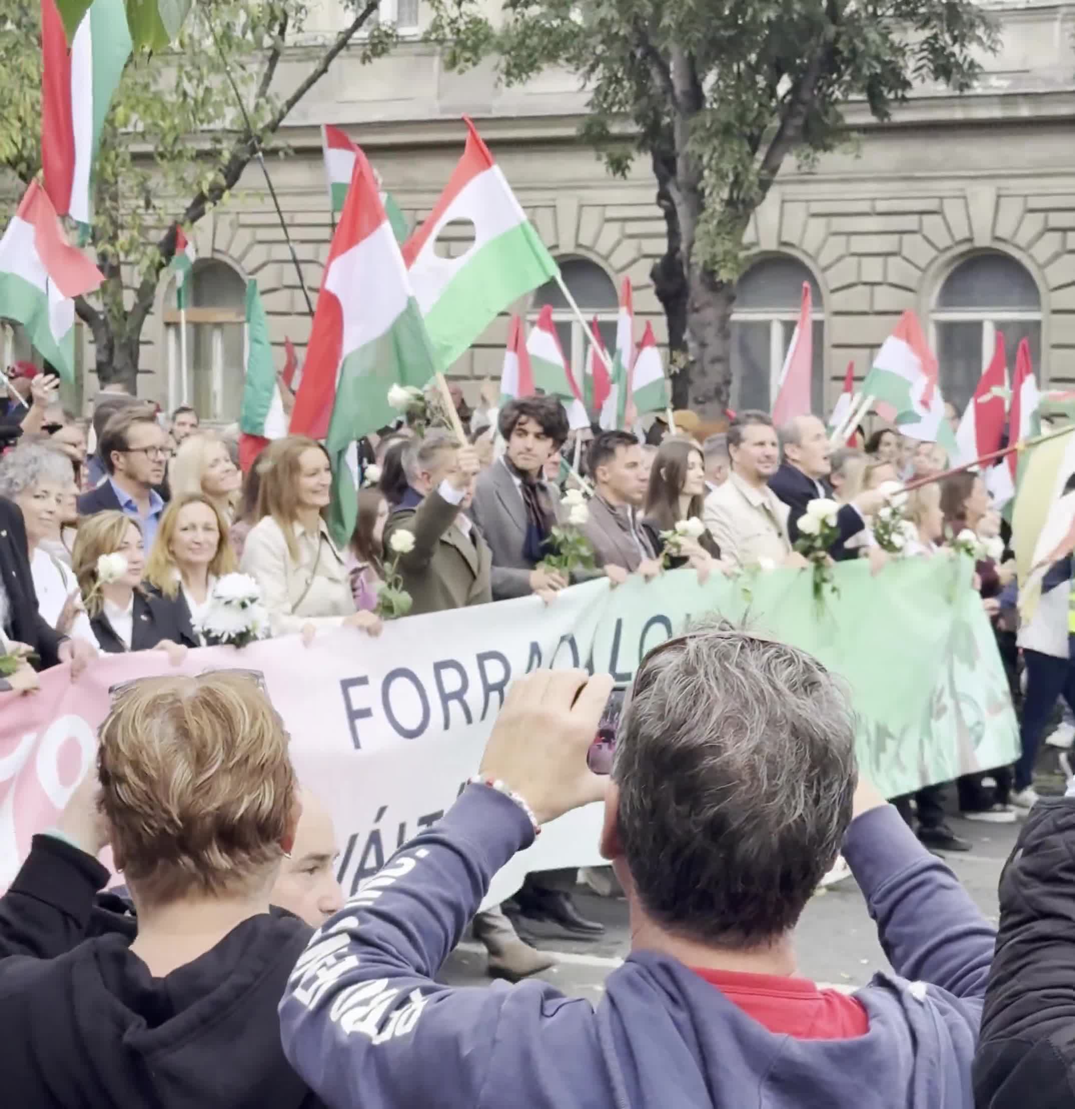 Budapest marks the anniversary of the 1956 anti-Soviet revolution with two major rallies. Orbán’s “peace march,” led by a banner reading “We won’t die for Ukraine,” has ended — now opposition leader Péter Magyar’s “national march” heads with supporters toward Heroes’ Square